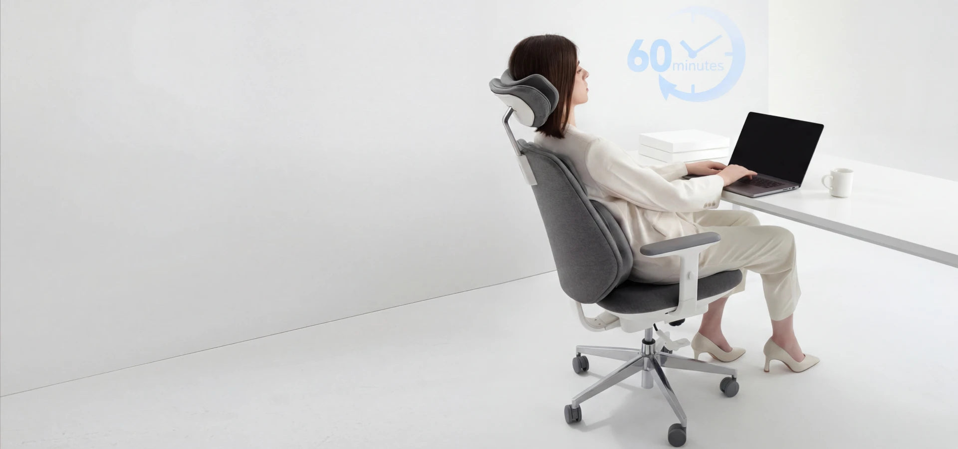 Woman using Air-Smart ergonomic office chair with auto-following lumbar support at desk