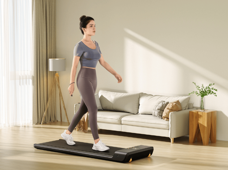 A woman is standing on a treadmill