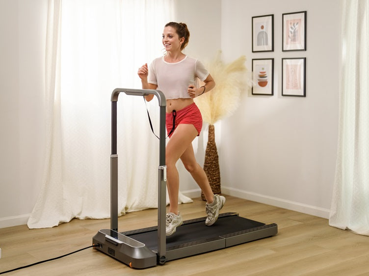 Woman using a WalkingPad R2 foldable treadmill for home workouts