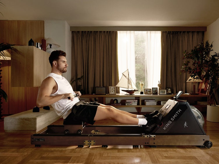 Man using the WalkingPad WR20 rowing machine for a full-body indoor workout at home