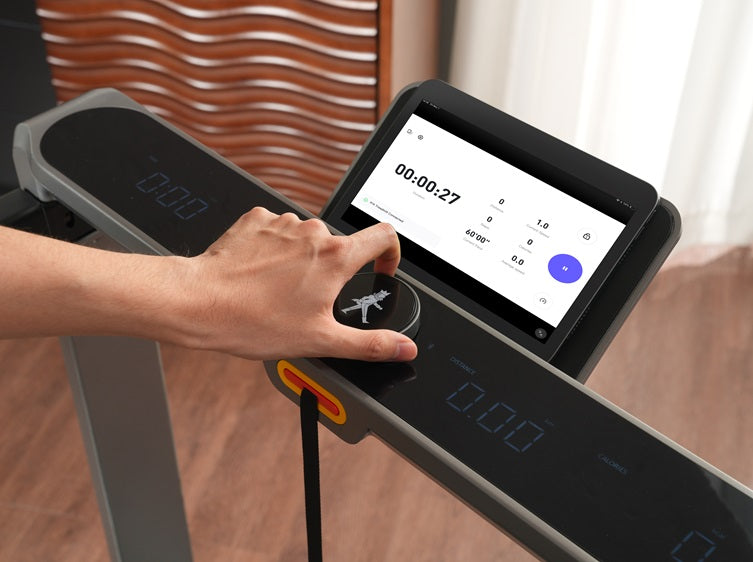 Hand adjusting the SpeedDial™ controller on the WalkingPad X214 treadmill