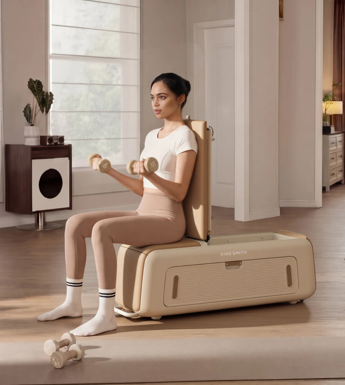 woman using pilates bench with dumbbells seated workout