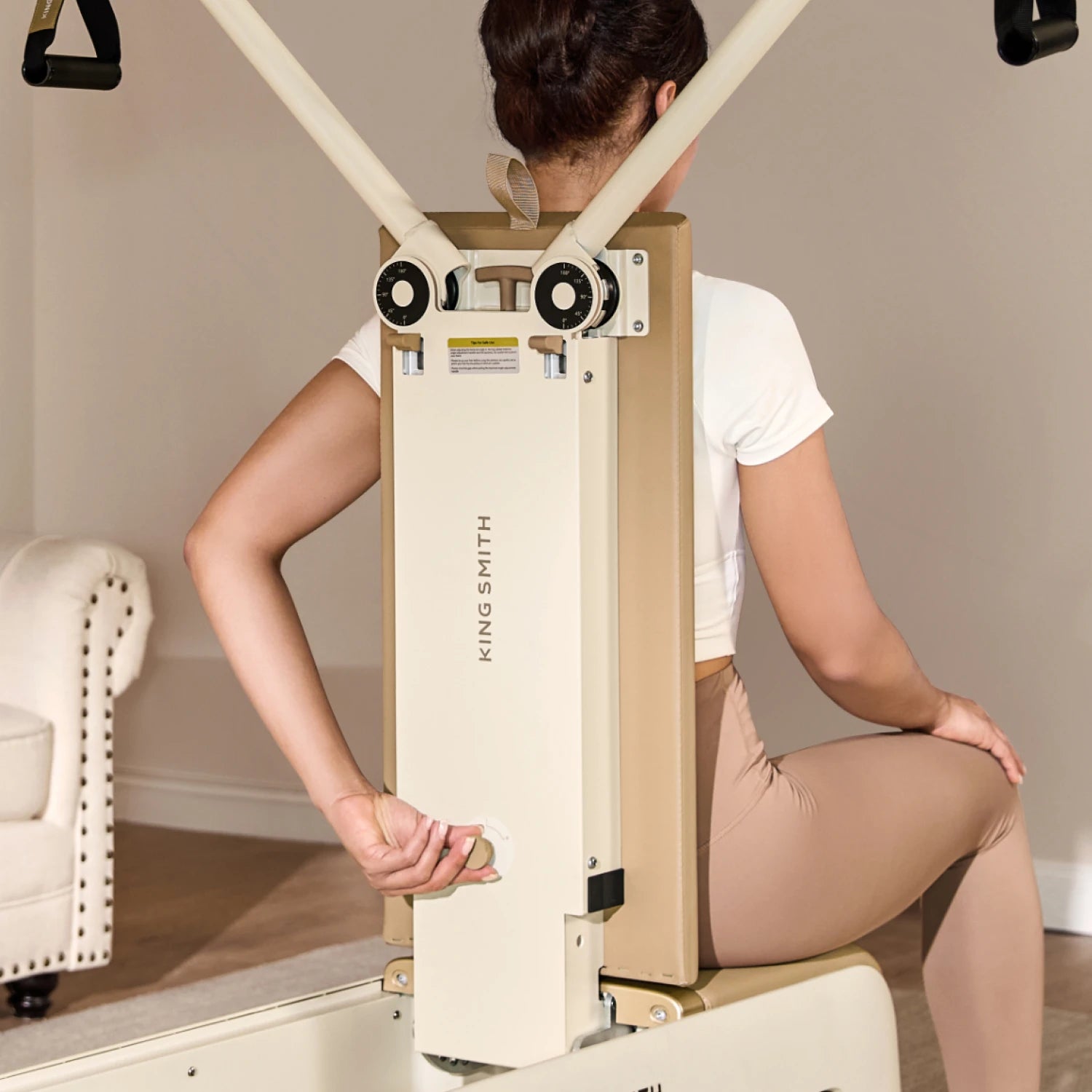 adjusting resistance knob on pilates bench back control system