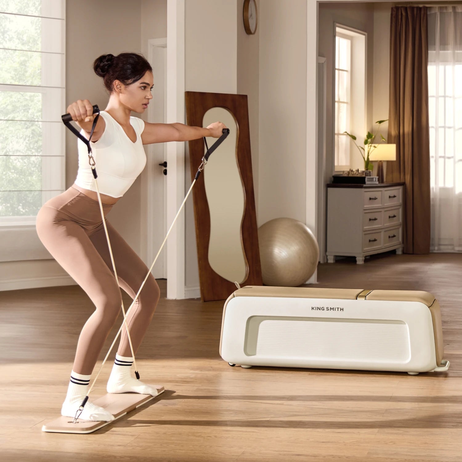 woman performing resistance band training on pilates bench