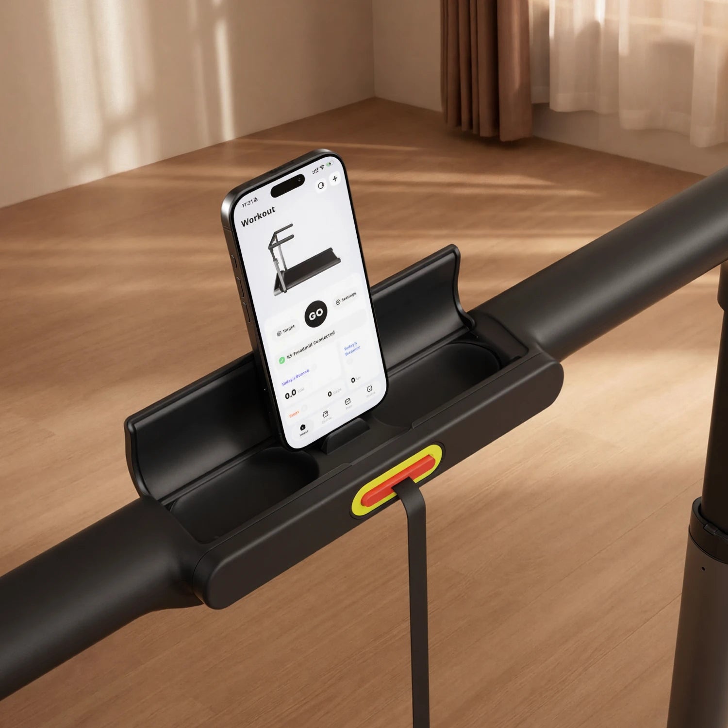 Close-up of MX3 treadmill's flip-up phone holder with smartphone showing companion app.