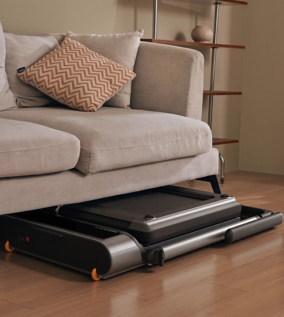 MX3 treadmill stored under sofa, highlighting its super compact foldable design.