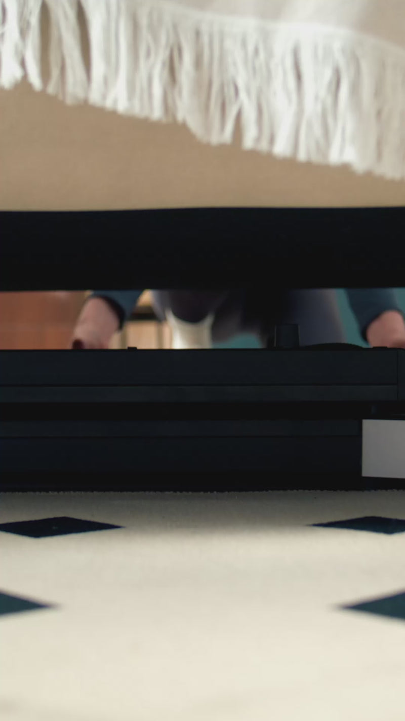 WalkingPad Z1 treadmill used under desk for walking while working at home
