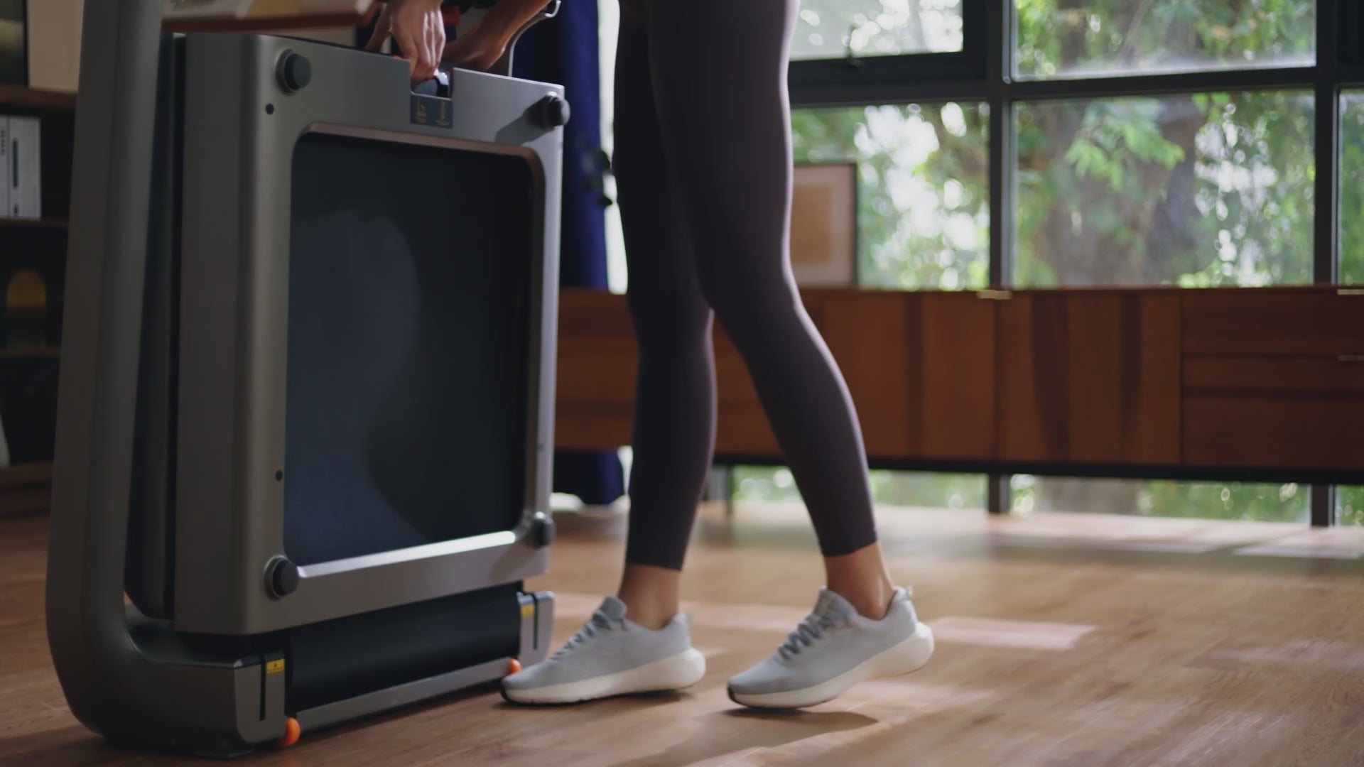 Load video: Woman running on the WalkingPad X218 foldable treadmill during an indoor workout