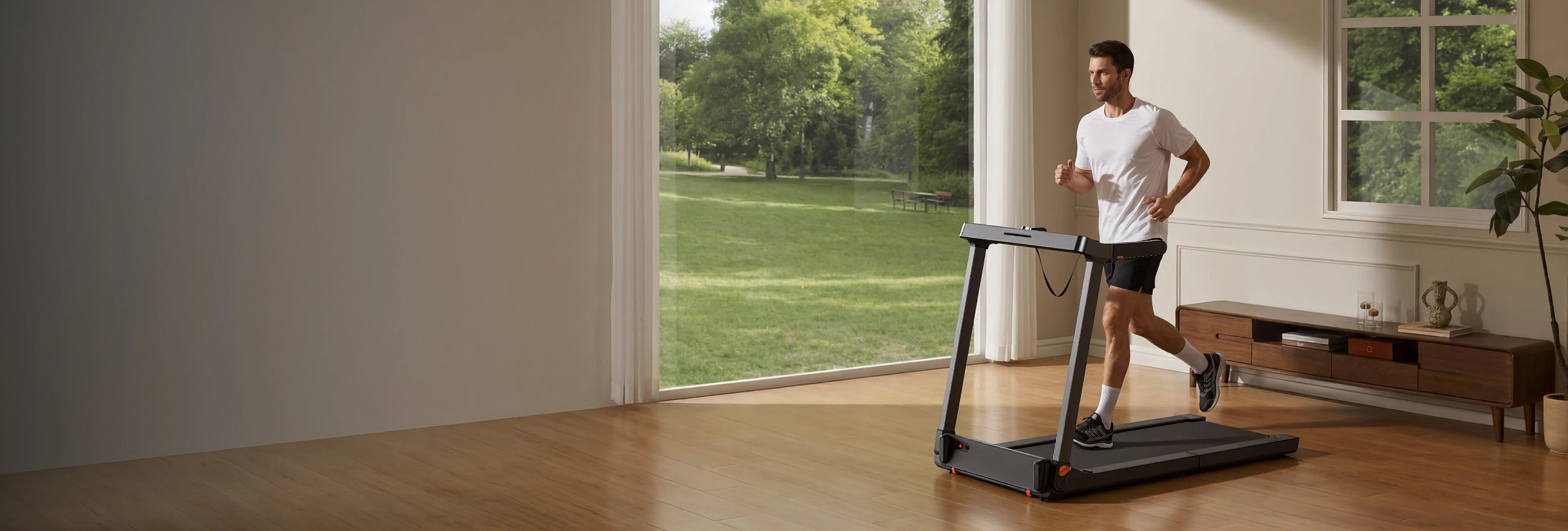 Person walking on a WalkingPad treadmill during a home workout in a modern living room
