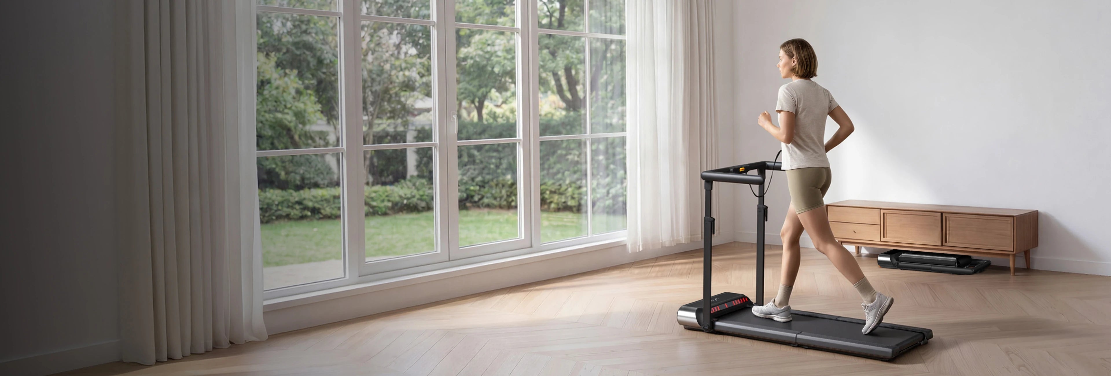 Man running on a WalkingPad treadmill for indoor cardio exercise at home
