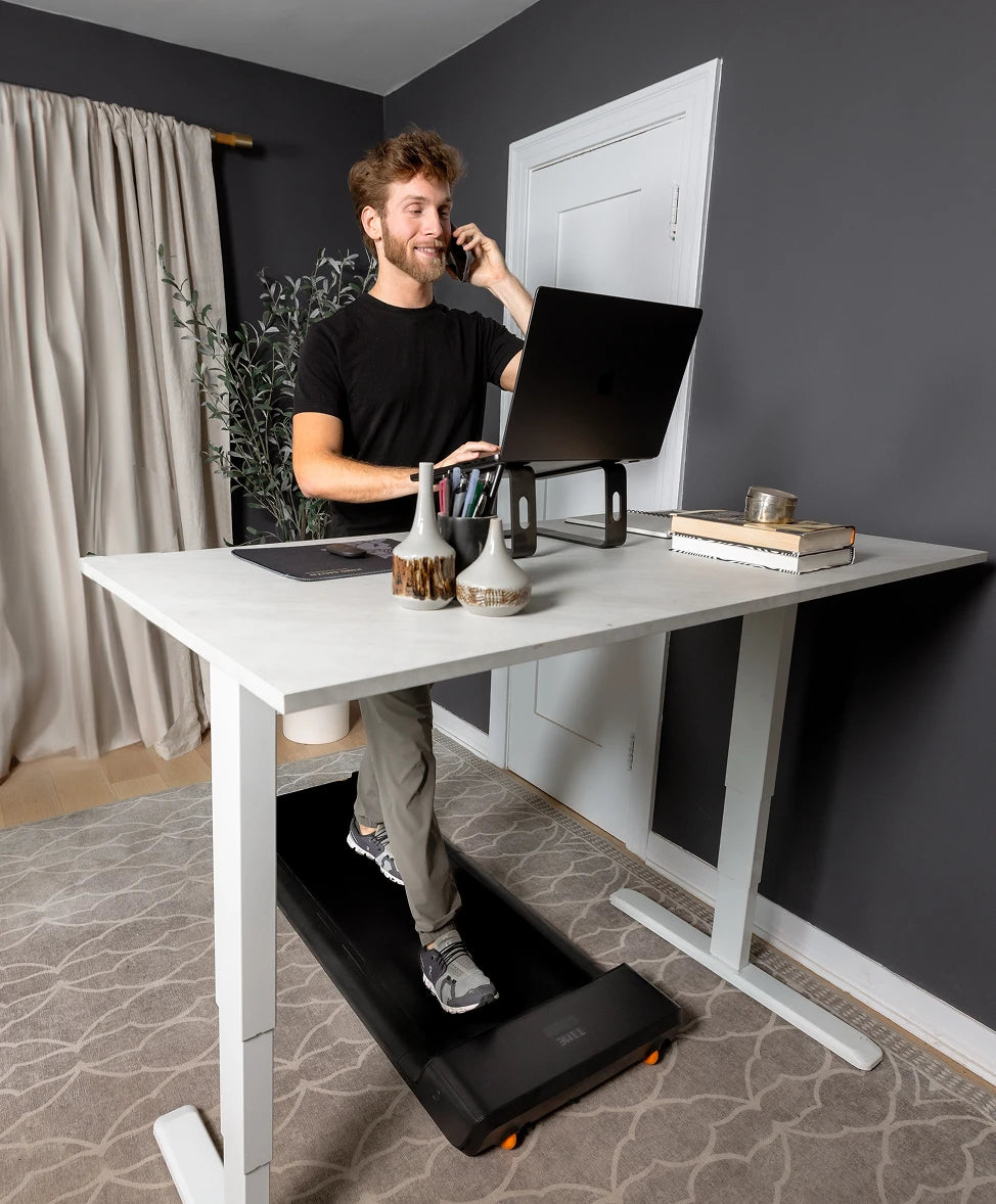 WalkingPad A1 Pro treadmill used under standing desk for walking while working