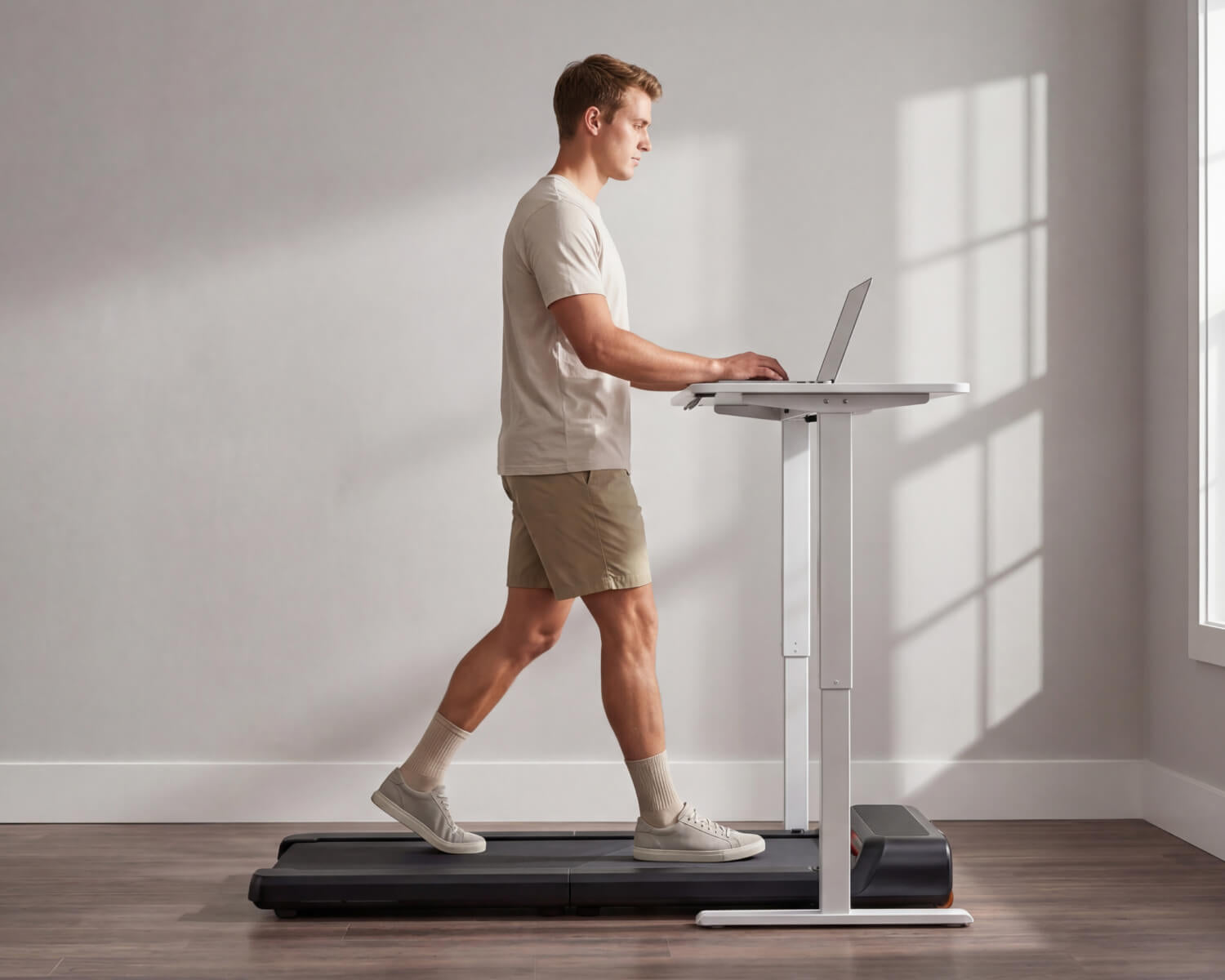 Man walking on a WalkingPad compact walking pad treadmill while working at a standing desk