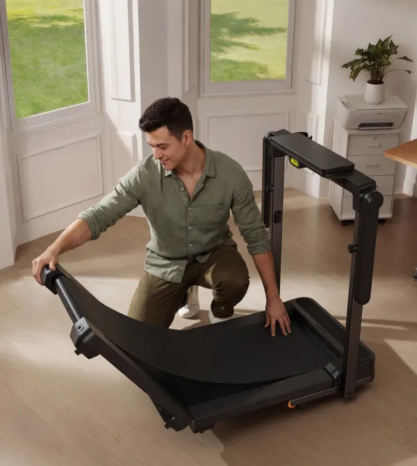 Man folding the WalkingPad MX10 vertical fold treadmill for compact storage