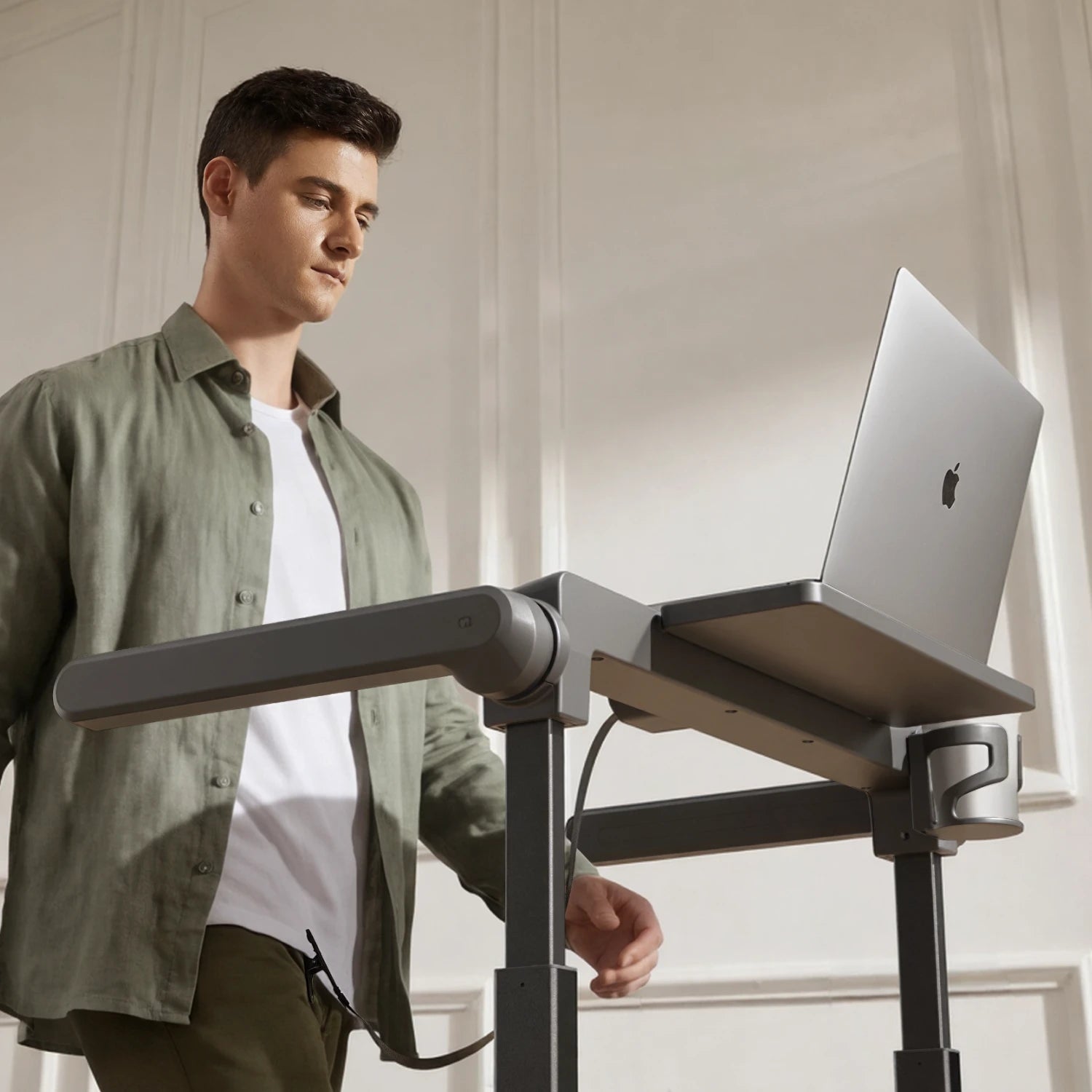 Man walking on the WalkingPad MX10 treadmill during a meeting with a quiet brushless motor