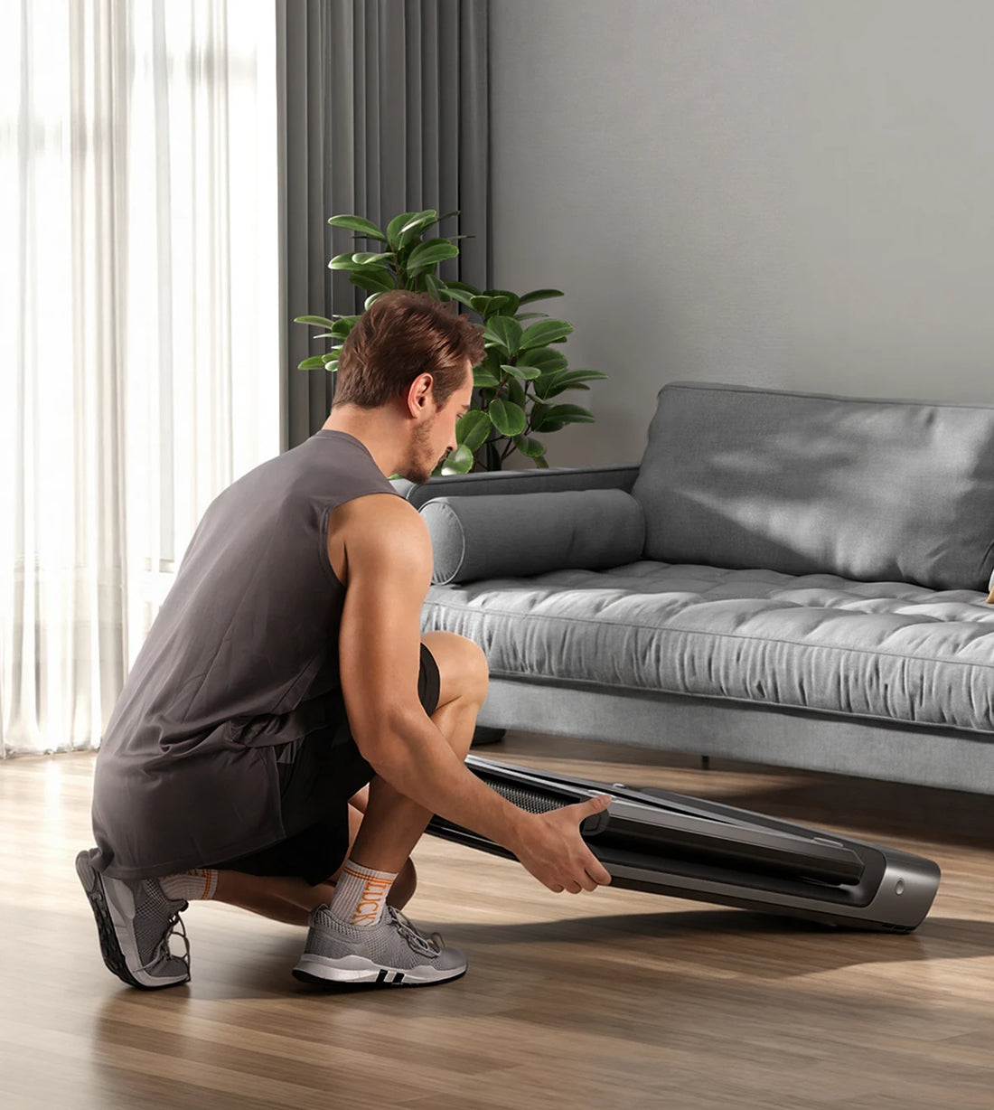 WalkingPad P1 treadmill stored under sofa for flexible space saving storage