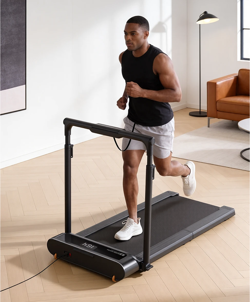 Man running on WalkingPad R3 Hybrid treadmill in a bright home environment