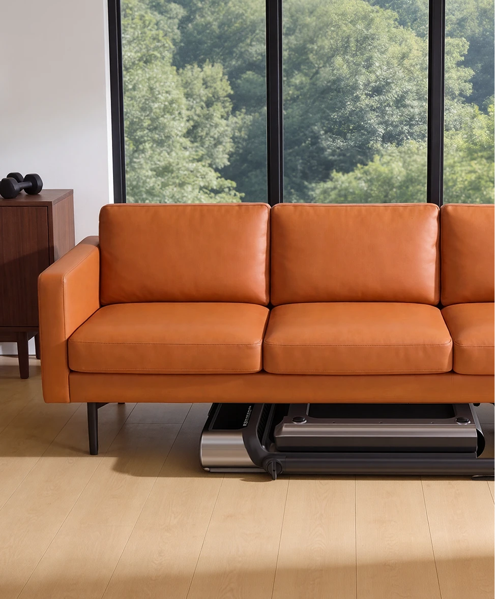 WalkingPad R3 Hybrid treadmill stored under a sofa to save space in a small living room