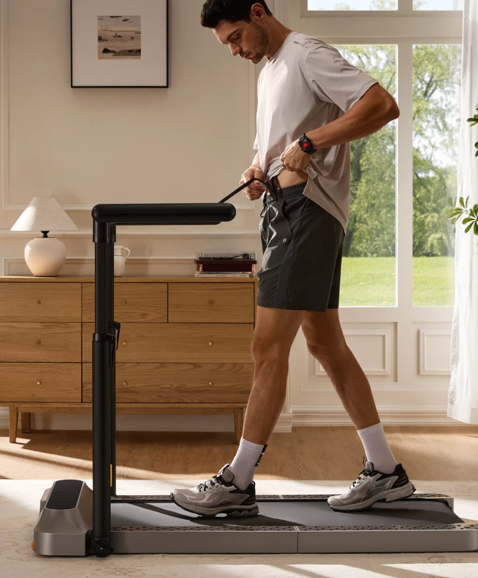 man using treadmill at home casual walking exercise setup