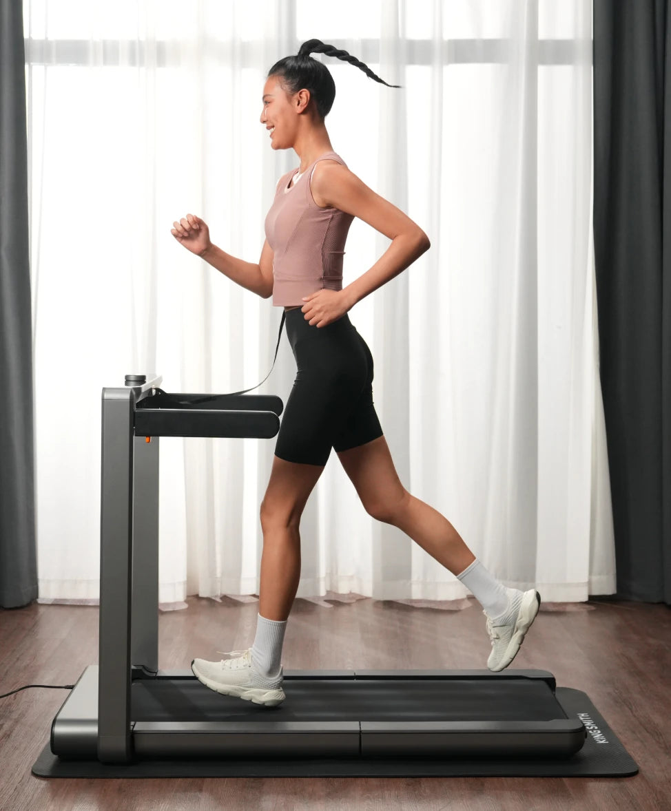 woman jogging on treadmill indoor home fitness routine