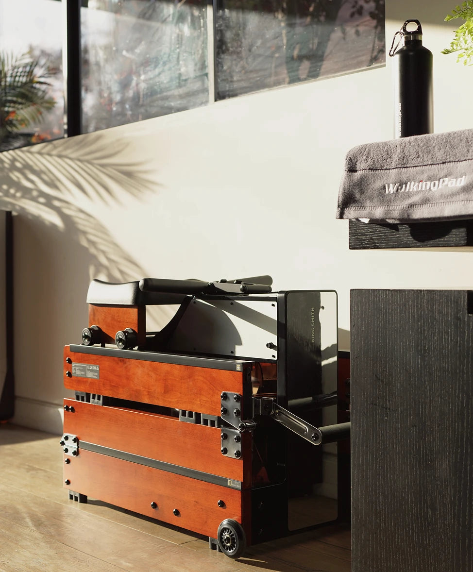 WalkingPad WM10 rowing machine stored neatly under furniture to save space