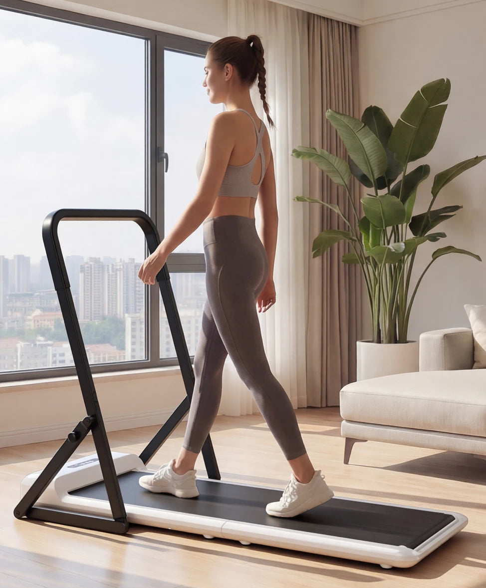 woman walking on treadmill with handrail indoor lifestyle fitness