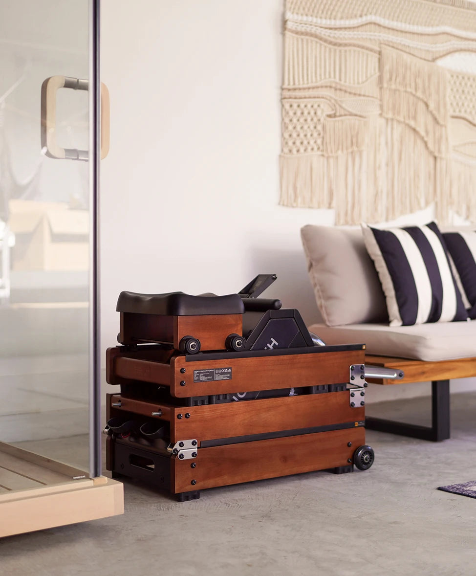 WalkingPad WR20 rowing machine stored beside bed as compact furniture piece