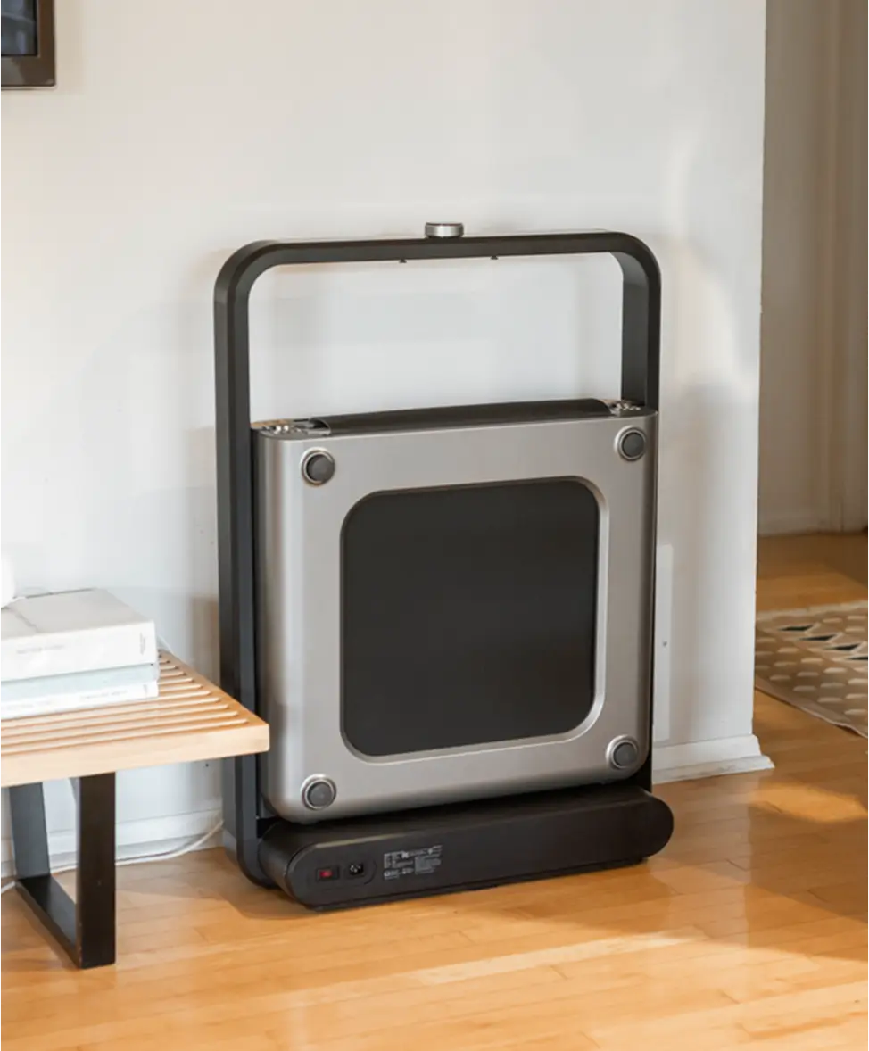 WalkingPad X21 foldable treadmill stored upright to save space at home
