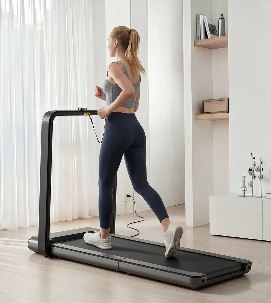Woman running on the WalkingPad X21 foldable treadmill during an indoor workout

