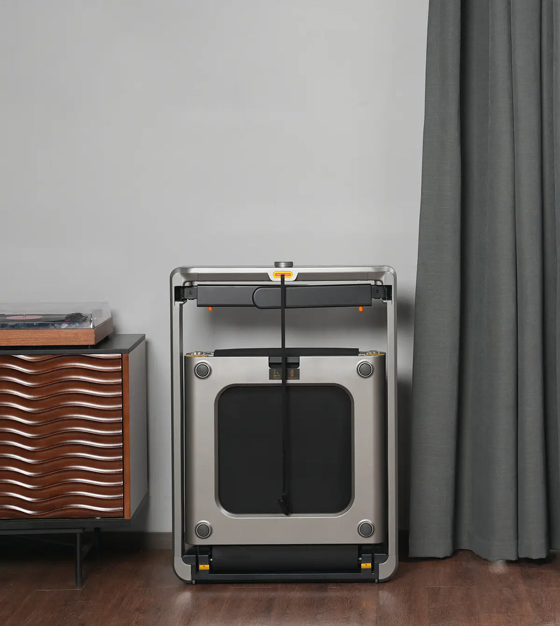 WalkingPad X214 foldable treadmill stored neatly against a wall for compact home storage