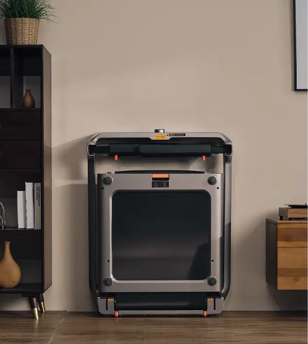 WalkingPad X218 foldable treadmill stored upright in a living room to save space