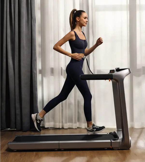 Woman running on the WalkingPad X218 foldable treadmill during an indoor workout