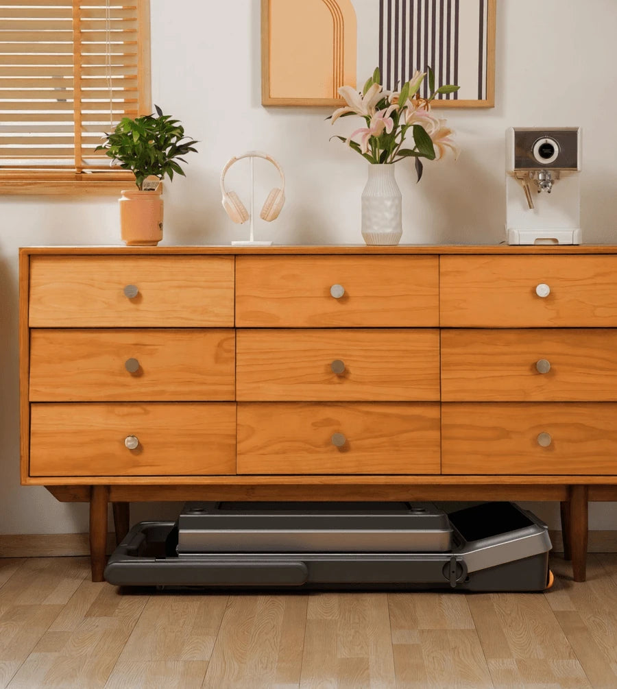 WalkingPad Z3 Hybrid Plus treadmill stored under a sofa to save space in a small living room